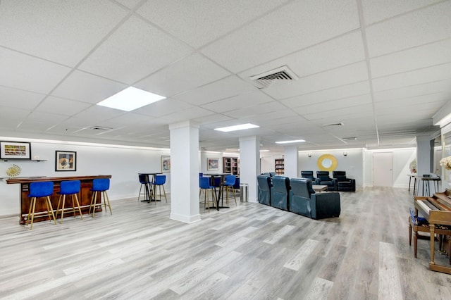 3546 S Ocean Blvd Unit 203, South Palm Beach, FL 33480 - living room featuring a dry bar, wood finished floors, baseboards, and a paneled ceiling