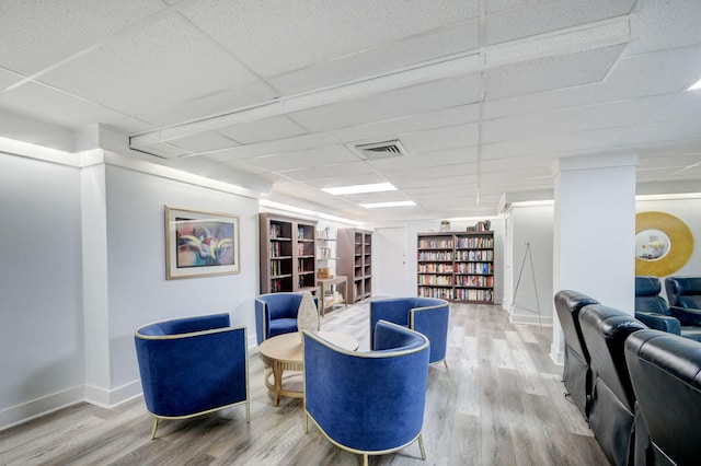 3546 S Ocean Blvd Unit 203, South Palm Beach, FL 33480 - living area featuring a paneled ceiling, wood finished floors, baseboards, and built in features