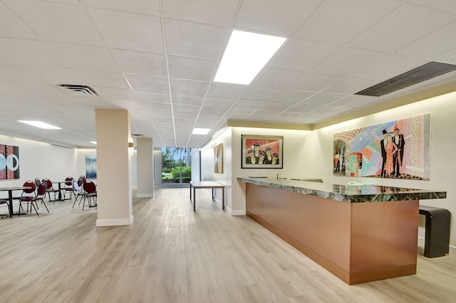 3546 S Ocean Blvd Unit 203, South Palm Beach, FL 33480 - bar area with light wood-type flooring, baseboards, and a drop ceiling