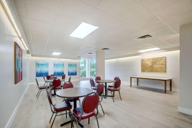 3546 S Ocean Blvd Unit 203, South Palm Beach, FL 33480 - dining room featuring wood finished floors, baseboards, and a paneled ceiling