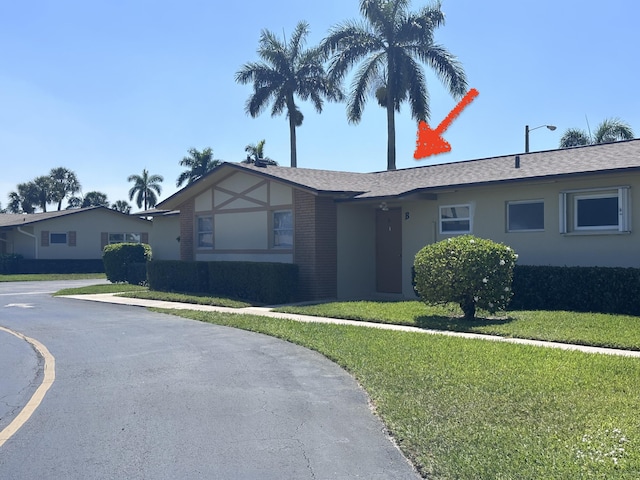 2842 Crosley Dr W Unit B, West Palm Beach, FL 33415 - view of front facade featuring a front lawn