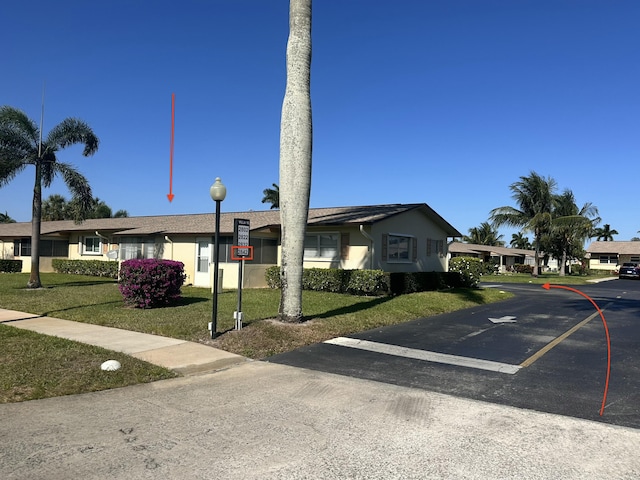 2842 Crosley Dr W Unit B, West Palm Beach, FL 33415 - ranch-style home with a front lawn, uncovered parking, and stucco siding