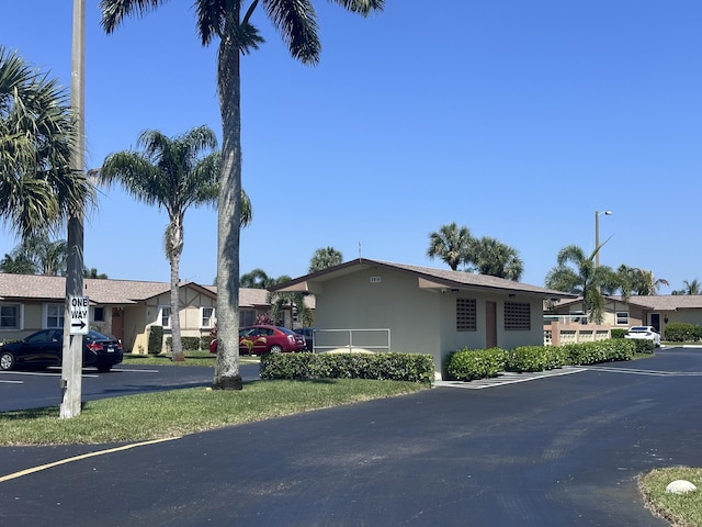 2842 Crosley Dr W Unit B, West Palm Beach, FL 33415 - view of front of home with stucco siding, uncovered parking, and a residential view