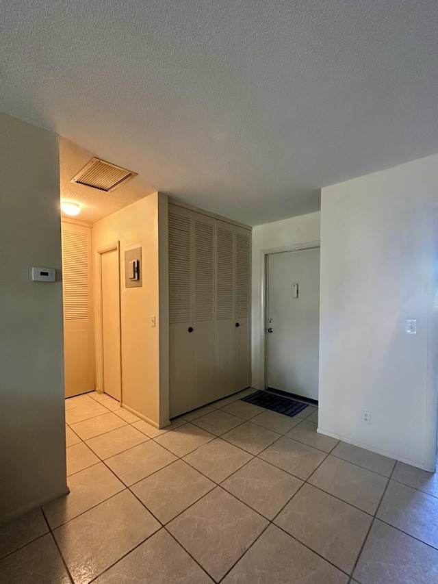 2842 Crosley Dr W Unit B, West Palm Beach, FL 33415 - corridor with light tile patterned flooring and a textured ceiling