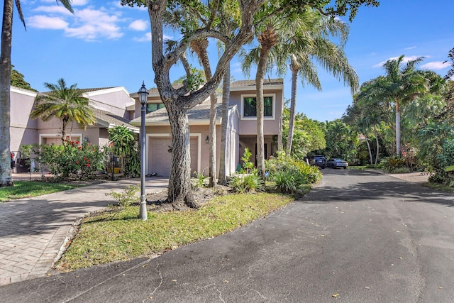 6650 Thornhill Ct, Boca Raton, FL 33433 - view of front of home featuring stucco siding, an attached garage, and driveway