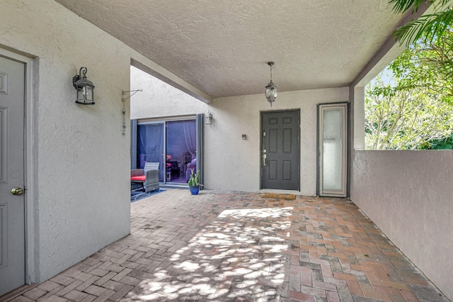 6650 Thornhill Ct, Boca Raton, FL 33433 - doorway to property with stucco siding and a patio