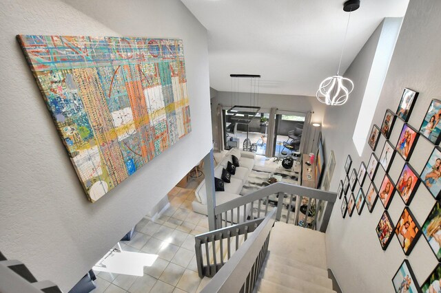 6650 Thornhill Ct, Boca Raton, FL 33433 - stairs with a chandelier and tile patterned floors