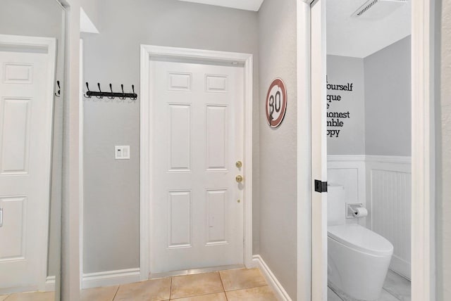 6650 Thornhill Ct, Boca Raton, FL 33433 - bathroom featuring toilet, tile patterned flooring, wainscoting, and baseboards