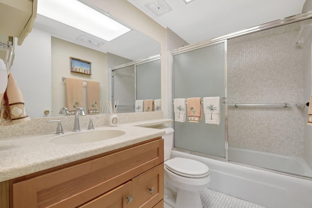 5505 N Ocean Blvd Unit 13-105, Ocean Ridge, FL 33435 - bathroom with tile patterned flooring, vanity, bath / shower combo with glass door, and toilet