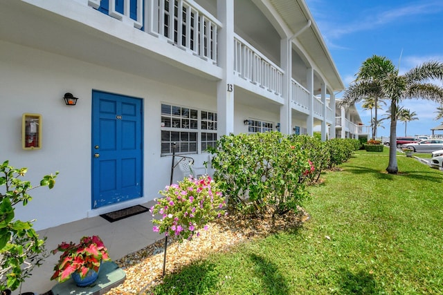 5505 N Ocean Blvd Unit 13-105, Ocean Ridge, FL 33435 - entrance to property featuring stucco siding and a lawn