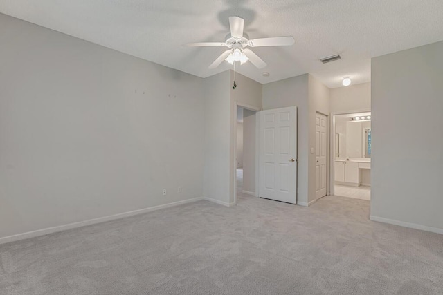 7886 Laina Ln Unit 2, Boynton Beach, FL 33437 - unfurnished bedroom featuring carpet, baseboards, ensuite bath, a ceiling fan, and a textured ceiling