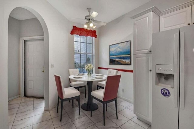7886 Laina Ln Unit 2, Boynton Beach, FL 33437 - dining space featuring arched walkways, ceiling fan, and baseboards