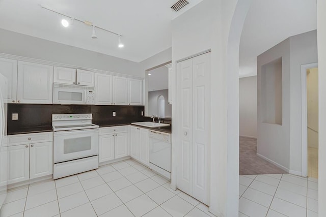 7886 Laina Ln Unit 2, Boynton Beach, FL 33437 - kitchen with white appliances, arched walkways, a sink, white cabinets, and dark countertops