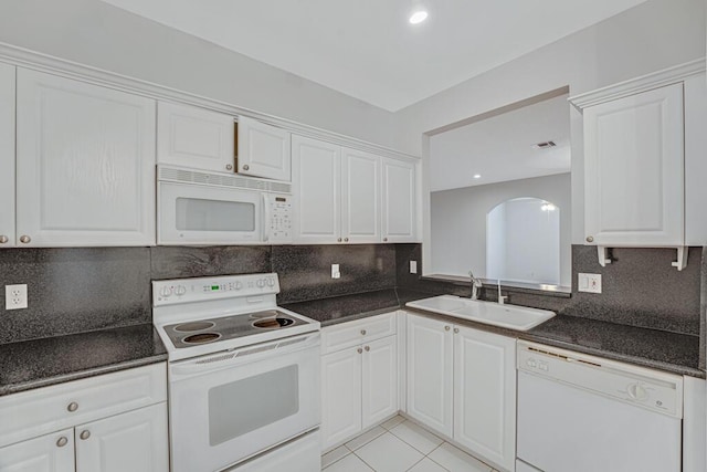 7886 Laina Ln Unit 2, Boynton Beach, FL 33437 - kitchen with white appliances, a sink, dark countertops, white cabinets, and decorative backsplash