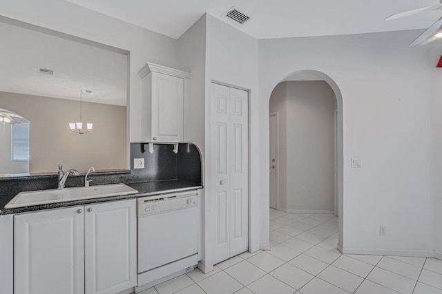 7886 Laina Ln Unit 2, Boynton Beach, FL 33437 - kitchen featuring white dishwasher, dark countertops, a sink, white cabinetry, and arched walkways