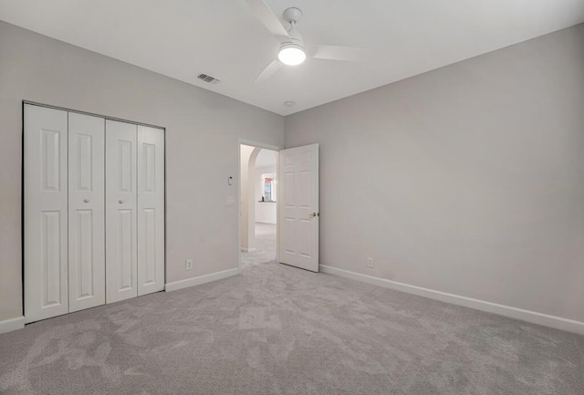 7886 Laina Ln Unit 2, Boynton Beach, FL 33437 - unfurnished bedroom with carpet flooring, baseboards, arched walkways, a closet, and a ceiling fan