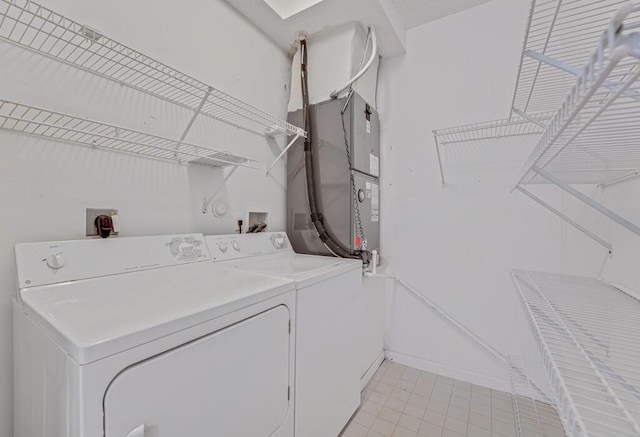 7886 Laina Ln Unit 2, Boynton Beach, FL 33437 - laundry room with independent washer and dryer, baseboards, heating unit, and light tile patterned floors