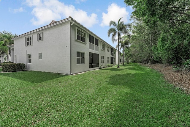 7886 Laina Ln Unit 2, Boynton Beach, FL 33437 - back of property with stucco siding and a yard