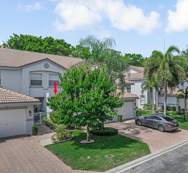 7886 Laina Ln Unit 2, Boynton Beach, FL 33437 - view of front facade with a tile roof, decorative driveway, stucco siding, and a front yard