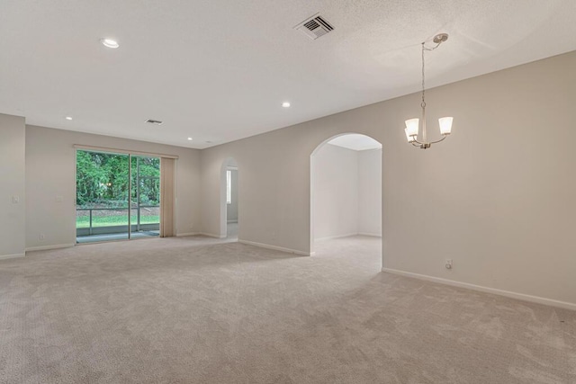 7886 Laina Ln Unit 2, Boynton Beach, FL 33437 - unfurnished room featuring light colored carpet, arched walkways, baseboards, a chandelier, and recessed lighting