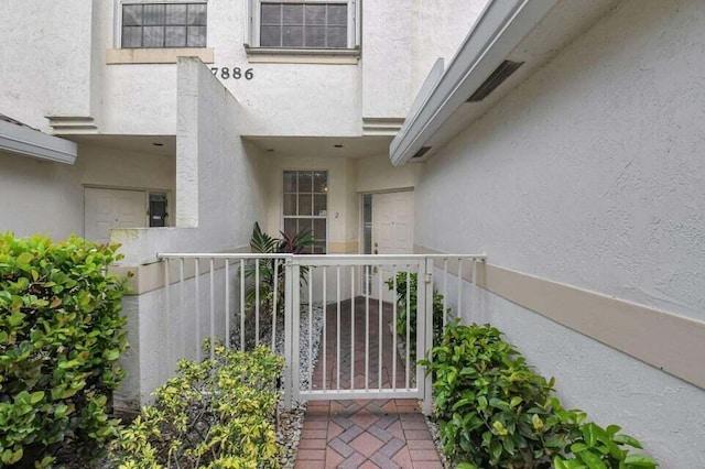 7886 Laina Ln Unit 2, Boynton Beach, FL 33437 - view of exterior entry featuring stucco siding
