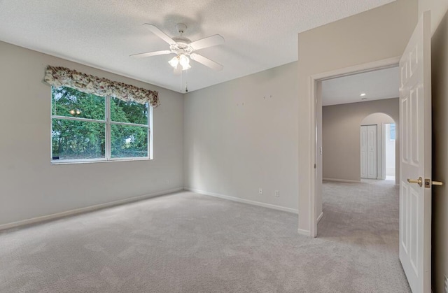 7886 Laina Ln Unit 2, Boynton Beach, FL 33437 - carpeted spare room with arched walkways, ceiling fan, baseboards, and a textured ceiling