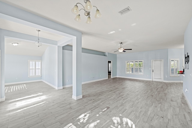 4672 SW Wade Dr, Port Saint Lucie, FL 34953 - unfurnished living room featuring a chandelier, baseboards, light wood-style flooring, and ceiling fan