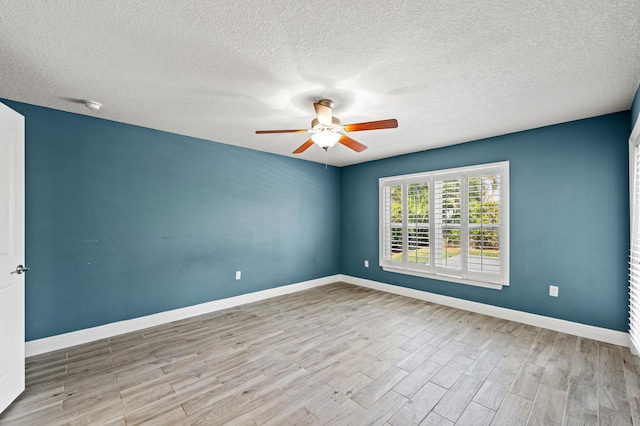 4672 SW Wade Dr, Port Saint Lucie, FL 34953 - unfurnished room with a ceiling fan, wood finished floors, a textured ceiling, baseboards, and a smoke detector