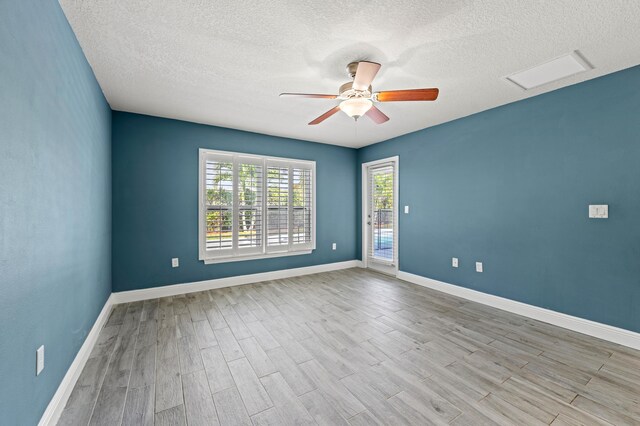 4672 SW Wade Dr, Port Saint Lucie, FL 34953 - empty room with wood finished floors, a ceiling fan, a textured ceiling, and baseboards