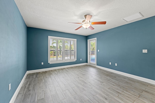 4672 SW Wade Dr, Port Saint Lucie, FL 34953 - spare room with wood finished floors, a ceiling fan, a textured ceiling, and baseboards