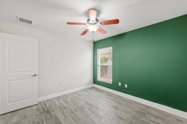 4672 SW Wade Dr, Port Saint Lucie, FL 34953 - unfurnished room featuring wood finished floors, a ceiling fan, baseboards, and a textured ceiling