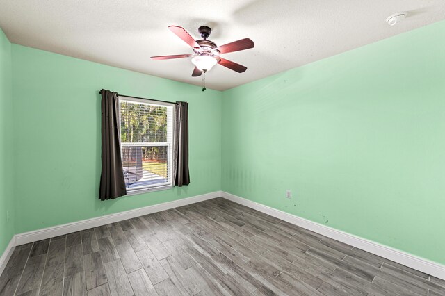 4672 SW Wade Dr, Port Saint Lucie, FL 34953 - empty room with a ceiling fan, wood finished floors, baseboards, and a smoke detector