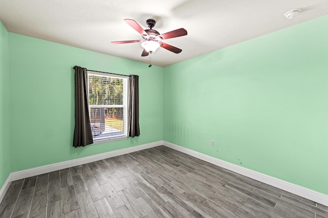 4672 SW Wade Dr, Port Saint Lucie, FL 34953 - spare room with a ceiling fan, wood finished floors, baseboards, and a smoke detector