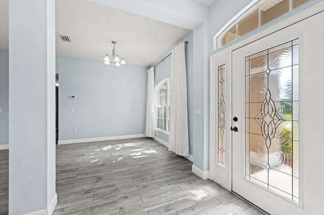 4672 SW Wade Dr, Port Saint Lucie, FL 34953 - entryway with a chandelier, baseboards, and wood finished floors