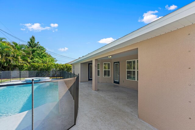 4672 SW Wade Dr, Port Saint Lucie, FL 34953 - view of swimming pool featuring a patio and a pool with connected hot tub