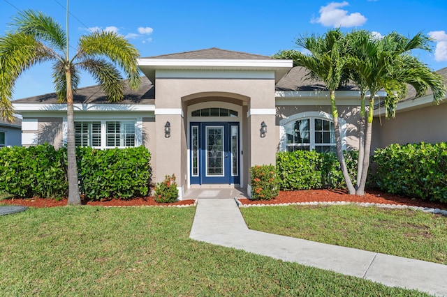 4672 SW Wade Dr, Port Saint Lucie, FL 34953 - property entrance featuring stucco siding and a yard