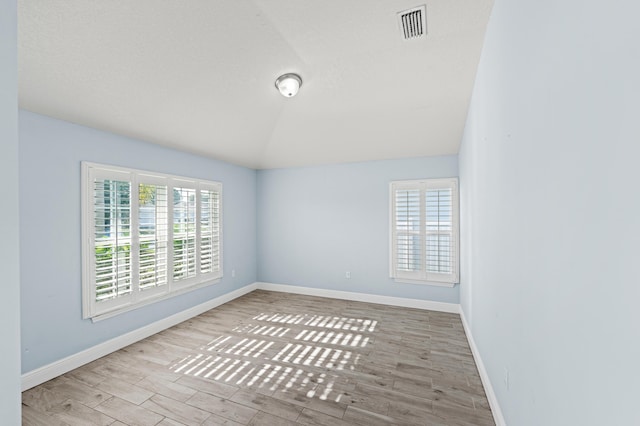 4672 SW Wade Dr, Port Saint Lucie, FL 34953 - spare room featuring healthy amount of natural light, lofted ceiling, and baseboards