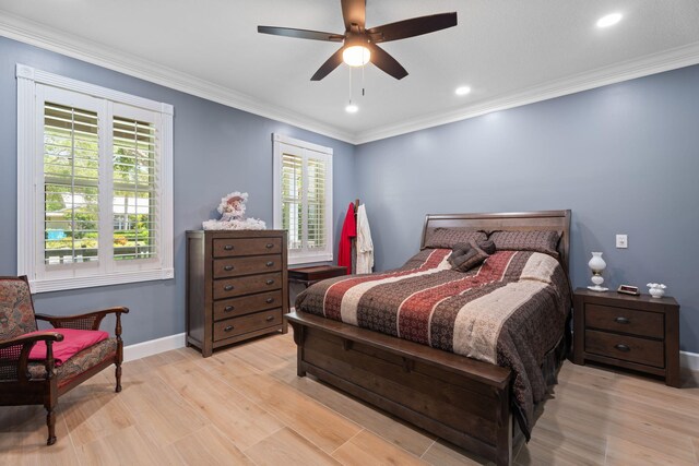 10 Copaire Rd, Sewalls Point, FL 34996 - bedroom with multiple windows, baseboards, light wood-style floors, crown molding, and ceiling fan