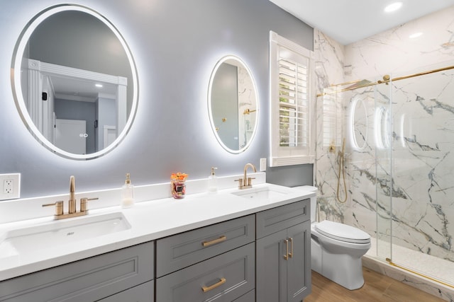 10 Copaire Rd, Sewalls Point, FL 34996 - bathroom with double vanity, a marble finish shower, toilet, and wood finished floors