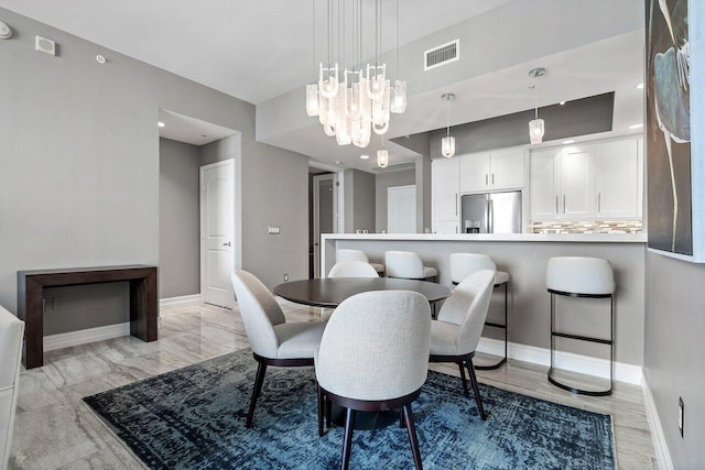 701 S Olive Ave Unit 923, West Palm Beach, FL 33401 - dining room featuring baseboards and a chandelier