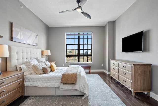 701 S Olive Ave Unit 923, West Palm Beach, FL 33401 - bedroom featuring dark wood-style flooring, baseboards, a textured ceiling, and ceiling fan