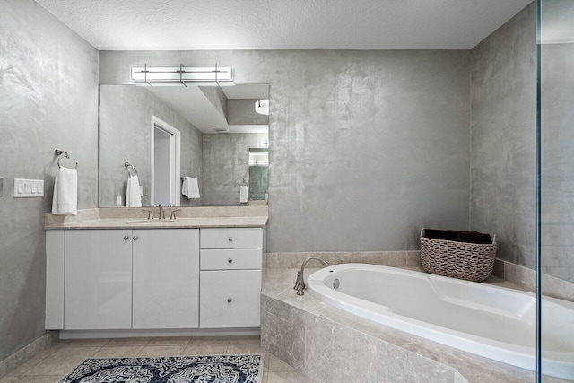 701 S Olive Ave Unit 923, West Palm Beach, FL 33401 - bathroom featuring a garden tub, vanity, tile patterned flooring, and a textured ceiling