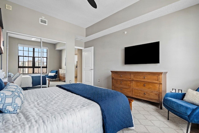 701 S Olive Ave Unit 923, West Palm Beach, FL 33401 - bedroom featuring light carpet, ceiling fan, and a textured ceiling