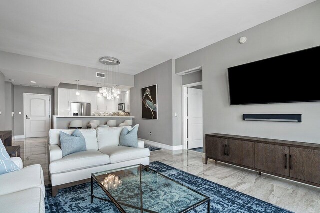 701 S Olive Ave Unit 923, West Palm Beach, FL 33401 - living room featuring baseboards, a chandelier, and recessed lighting