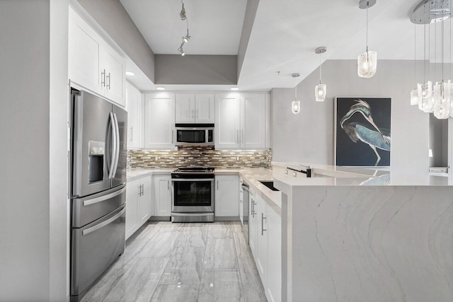 701 S Olive Ave Unit 923, West Palm Beach, FL 33401 - kitchen with appliances with stainless steel finishes, decorative backsplash, light marble finish floors, white cabinets, and hanging light fixtures