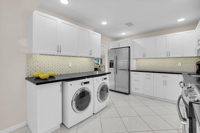 12 Westgate Ln Unit C, Boynton Beach, FL 33436 - kitchen featuring appliances with stainless steel finishes, separate washer and dryer, dark countertops, decorative backsplash, and recessed lighting