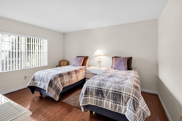 12 Westgate Ln Unit C, Boynton Beach, FL 33436 - bedroom with wood finished floors, baseboards, and a textured ceiling