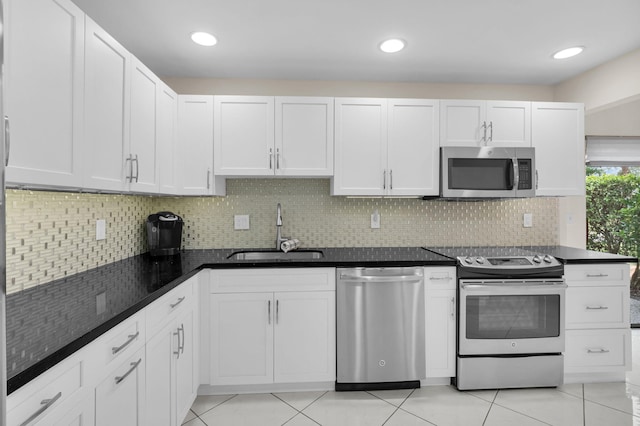 12 Westgate Ln Unit C, Boynton Beach, FL 33436 - kitchen featuring appliances with stainless steel finishes, a sink, tasteful backsplash, and white cabinetry