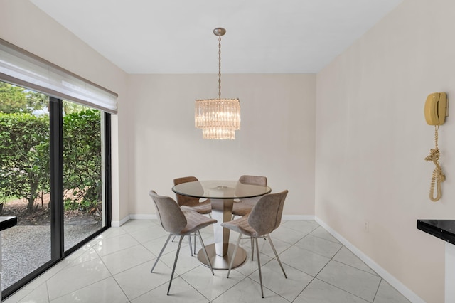 12 Westgate Ln Unit C, Boynton Beach, FL 33436 - dining room with a chandelier, baseboards, and light tile patterned floors