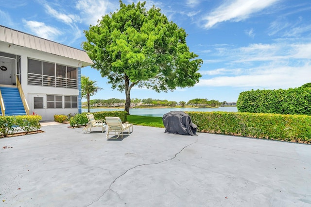 51 Stratford D, West Palm Beach, FL 33417 - view of patio featuring a water view, a sunroom, and area for grilling